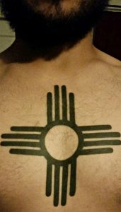 Owen Schwav got the Zia symbol tattooed on his chest after moving to Albuquerque. Photo by Mariah Rimmer / NM News Port 