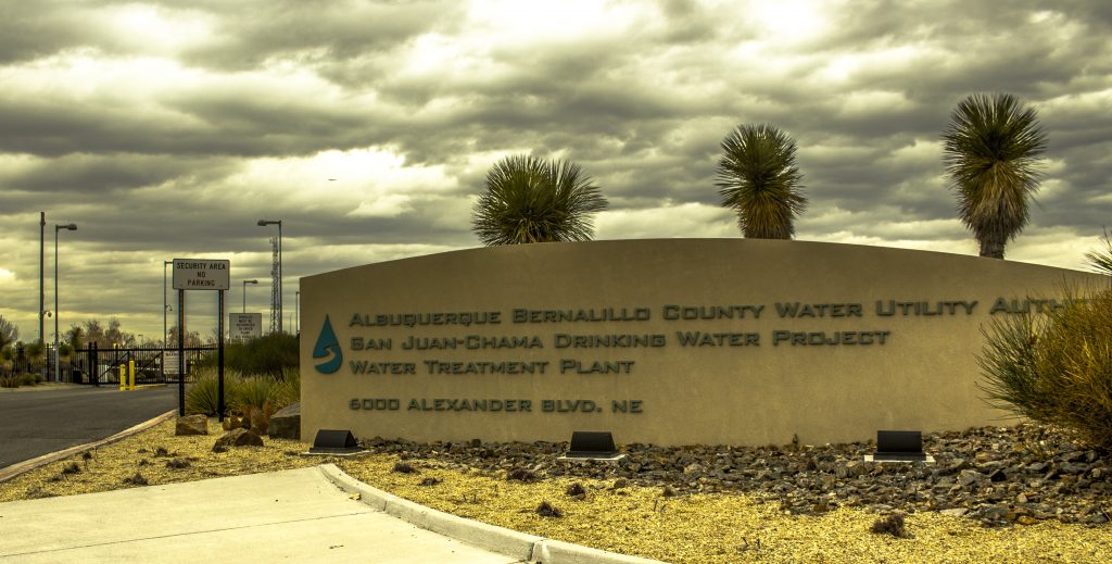 “water utility sign”                             Photo by Evan Barela Water from the Rio Grande is diverted to a $160 million Water Treatment Plant. The Plant, with a capacity of roughly 80 million gallons per day, employs both mechanical and chemical processes to remove contaminants from the water.  