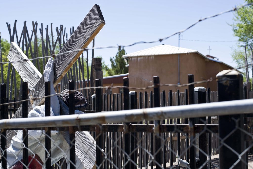 A statue of Jesus Christ stands next to a historic morada that is positioned deep in the south valley of Albuquerque, NM. on La Vega Blvd. Thursday, March 30, 2015. Photo by Nick Fojud