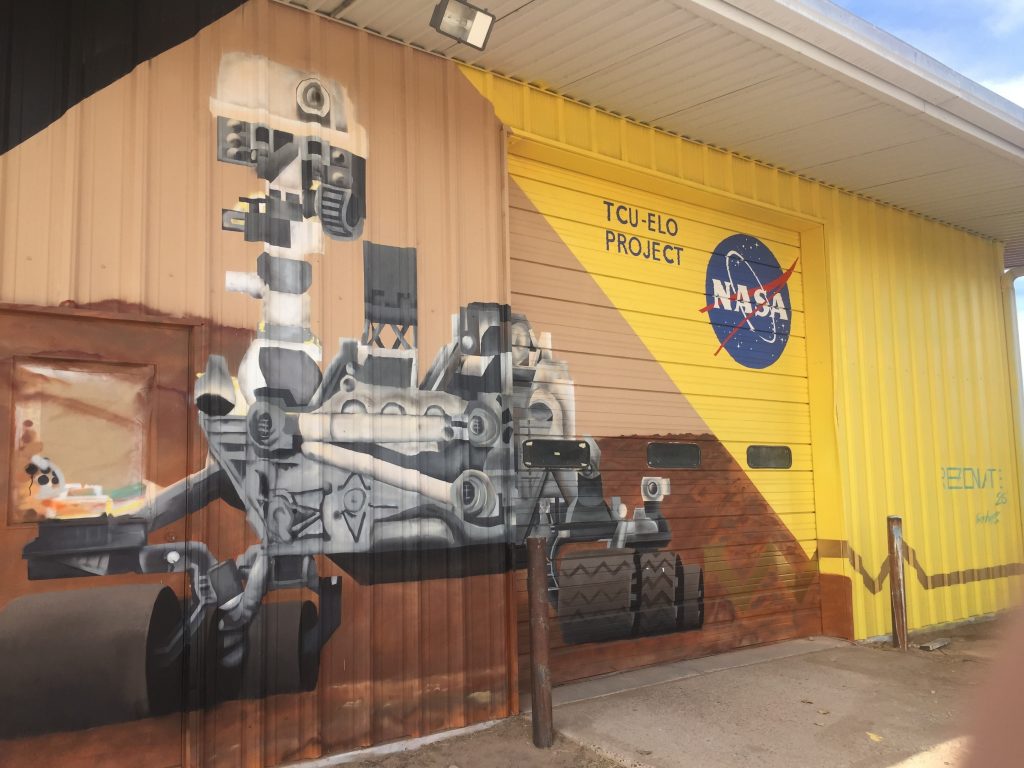 Mural of a rover painted on the side of the main Mars yard warehouse. (Photo by Elaine Baumgartel/KUNM)