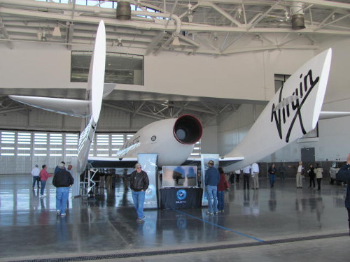 Visitors watch a TV screen explaining how Virgin Galactic’s ship is capable of taking passengers to space. Photo by Marissa Higdon / NM News Port. 