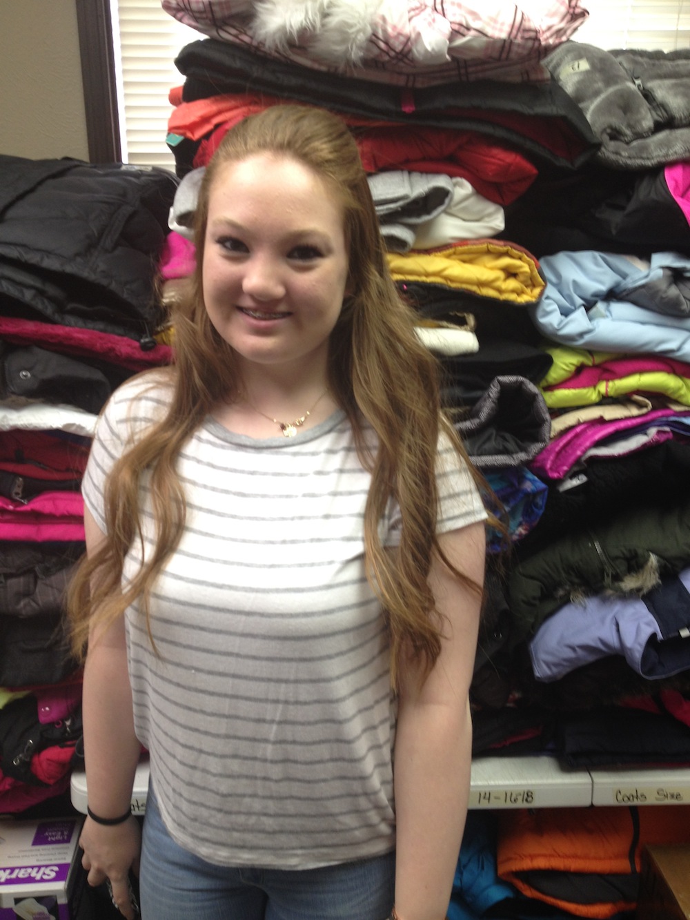 14-year-old Katie Dunavan volunteers at Locker #505. Volunteers make up the majority of the organization’s workforce; apart from Kerschen, there are only two part-time employees working for Locker #505. Photo by Brenna Kelley/ NM News Port