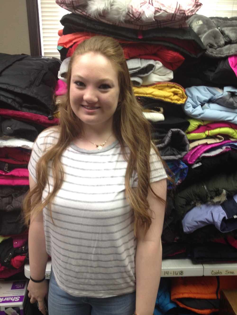 14-year-old Katie Dunavan volunteers at Locker #505. Volunteers make up the majority of the organization’s workforce; apart from Kerschen, there are only two part-time employees working for Locker #505. Photo by Brenna Kelley/ NM News Port 