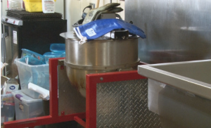 The main kettle corn machine with the custom made top inside the distribution center. The top has an agitator stirring the flavor of the popcorn. (Marino Spencer / NM News Port)