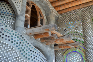 David Blanchet, an Earthship Academy student, enjoys spending his down time on his own personal balcony. This earthship room he is renting during his stay in Taos is part of a larger infrastructure called “EVE.” Photo by Brenna Kelley / NM News Port