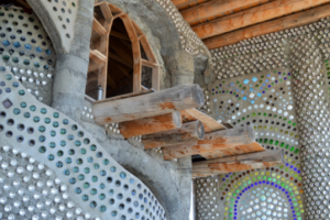 David Blanchet, an Earthship Academy student, enjoys spending his down time on his own personal balcony. This earthship room he is renting during his stay in Taos is part of a larger infrastructure called “EVE.” Photo by Brenna Kelley / NM News Port 