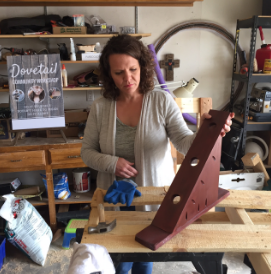Erin O’Donnell shows off a past "Brew and Build" project, which was a wine bottle holder. O’Donnell picks different projects for each Brew and Build event. Photo by Alisha Barber / NM News Port