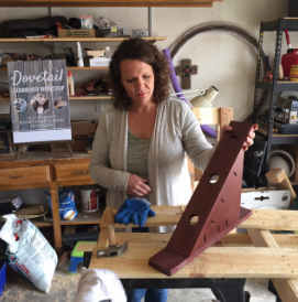 Erin O’Donnell shows off a past "Brew and Build" project, which was a wine bottle holder. O’Donnell picks different projects for each Brew and Build event. Photo by Alisha Barber / NM News Port 