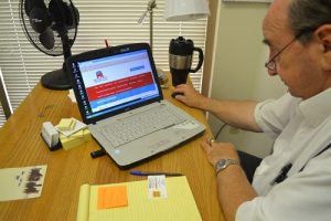 Frank Ruvolo updating the Bernalillo County Republican Party’s Website. Ruvolo keeps Bernalillo county Republicans aware of events and updated on news about the Republican party through the website. Photo by Natalie Baca / NM News Port