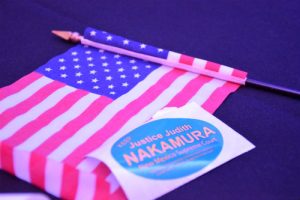 Justice Judith Nakamura wins the NM Supreme Court Race. Stickers and miniature U.S flags covered tables at the Republican Party on election night. (Photo taken by Allison Giron)